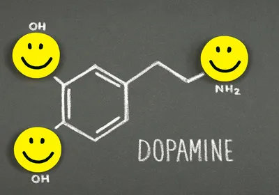 A drawing of a dopamine molecule with happy faces. A drawing of a dopamine molecule with happy faces.